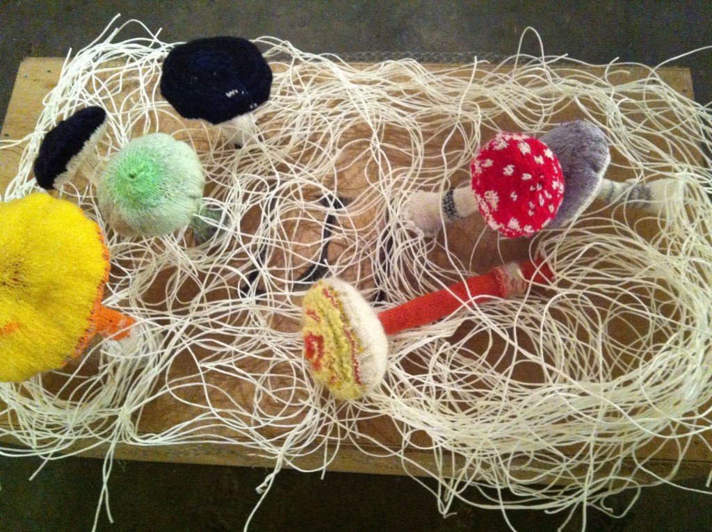 Knitted mushrooms with mycelia made from string.